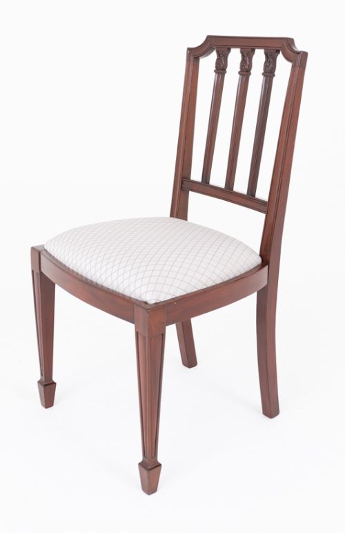 fig 3. A set of ten mahogany dining chairs featuring vertical splat backs, tapered legs with spade feet, and neutral patterned upholstered seats.