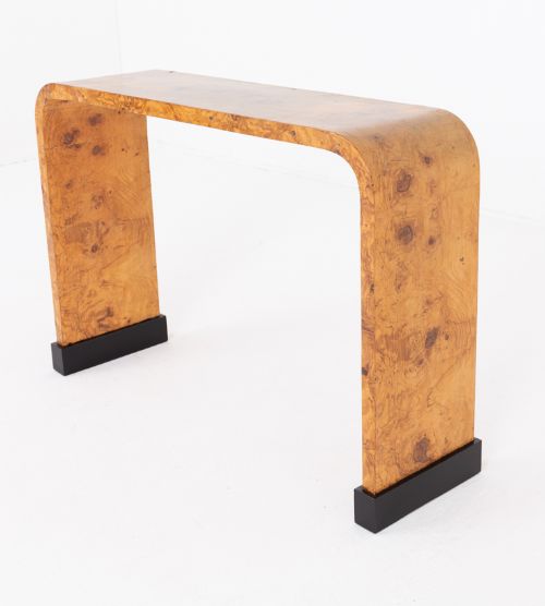 fig 1. An Art Deco waterfall console table constructed from burr walnut veneer with black ebonised block feet.