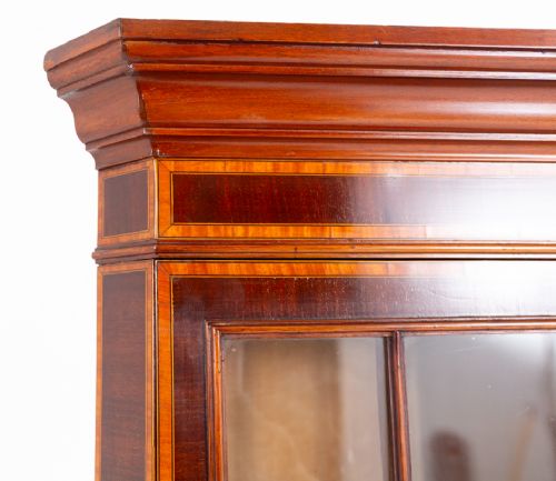 fig 2. A tall Sheraton Revival mahogany corner cabinet with an astragal glazed upper display section and a marquetry inlaid lower door panel.