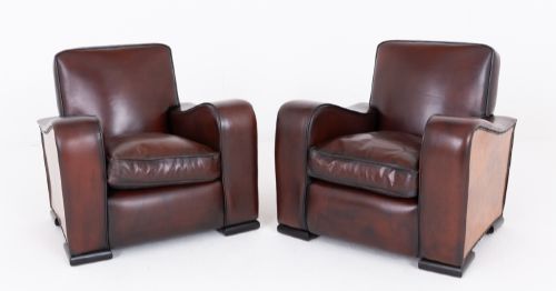 fig 1. A pair of Art Deco club chairs upholstered in brown leather with burr walnut side panels and studded trim.