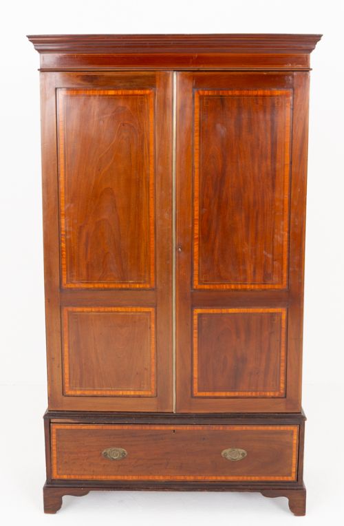 fig 1. A tall Sheraton Revival mahogany two-door wardrobe featuring inlaid panelled doors, a lower base drawer, and bracket feet.