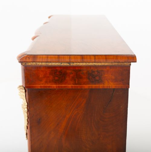 A Victorian burr walnut credenza featuring three arched glazed doors, intricate gilt ormolu mounts, and a solid plinth base. View IX