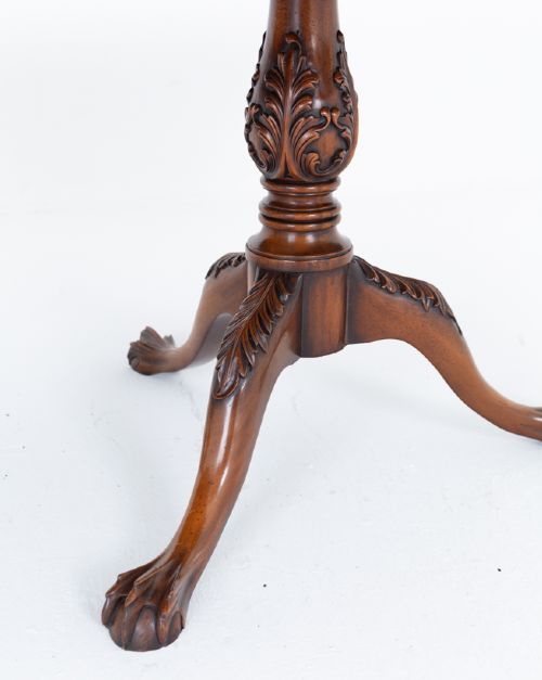 A Regency Revival twin-pedestal mahogany dining table featuring carved edging, turned support pillars, and splayed legs ending in carved feet. View IV