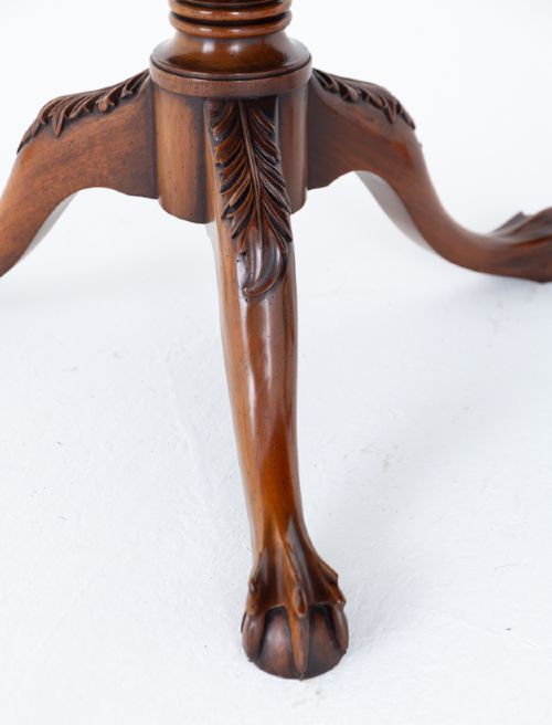 A Regency Revival twin-pedestal mahogany dining table featuring carved edging, turned support pillars, and splayed legs ending in carved feet. View VI