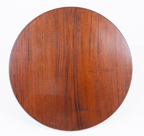 An extendable Regency Revival oval mahogany dining table with a central turned pedestal support, four reeded swept legs, and brass castors. View IV