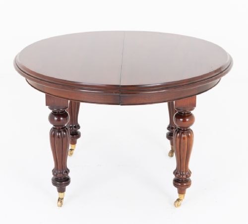 fig 1. A William IV mahogany extending dining table supported by four reeded turned legs with brass castors.