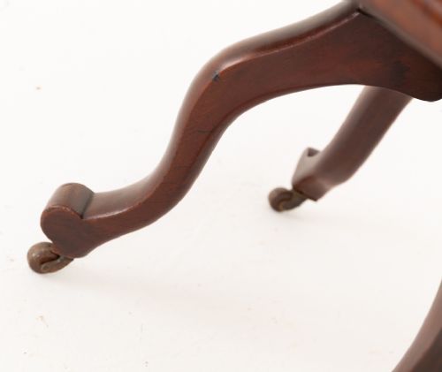Victorian mahogany swivel desk chair featuring a spindle back, rounded armrests, contoured wooden saddle seat, and splayed legs with castors. View III