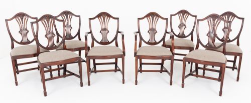 fig 1. A set of eight mahogany shield back dining chairs comprising six side chairs and two carvers with neutral beige fabric seats.