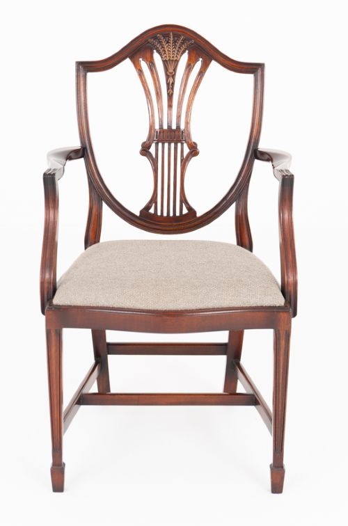fig 2. A set of eight mahogany shield back dining chairs comprising six side chairs and two carvers with neutral beige fabric seats.