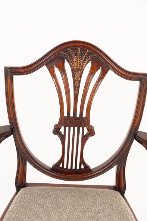A set of eight mahogany shield back dining chairs comprising six side chairs and two carvers with neutral beige fabric seats. View IV
