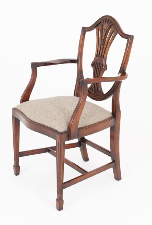 A set of eight mahogany shield back dining chairs comprising six side chairs and two carvers with neutral beige fabric seats. View V