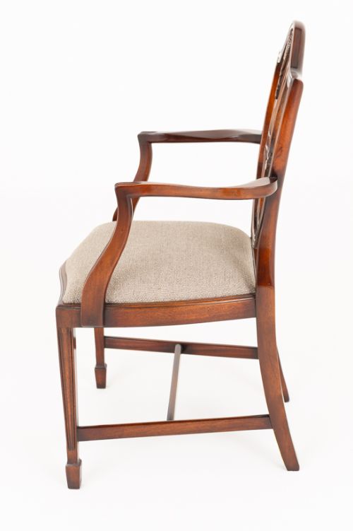A set of eight mahogany shield back dining chairs comprising six side chairs and two carvers with neutral beige fabric seats. View VI