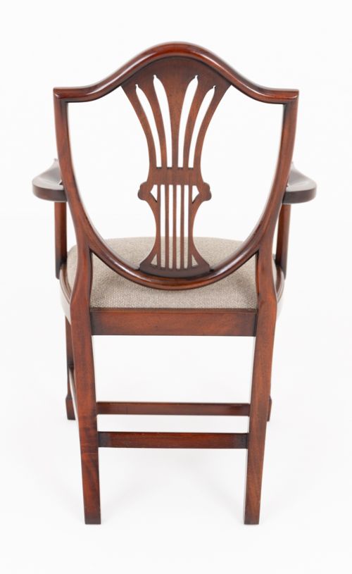 A set of eight mahogany shield back dining chairs comprising six side chairs and two carvers with neutral beige fabric seats. View VII