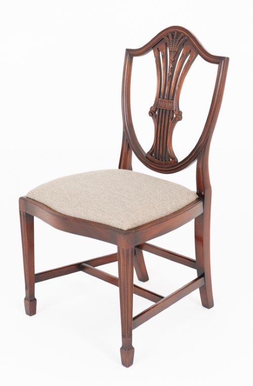 A set of eight mahogany shield back dining chairs comprising six side chairs and two carvers with neutral beige fabric seats. View IX