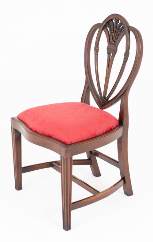 A set of twelve mahogany dining chairs with carved Prince of Wales plume backs and red damask fabric seats arranged in a arc. View V