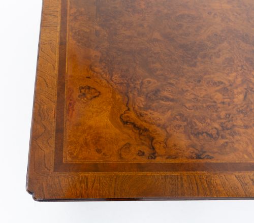 fig 2. A square low coffee table crafted from warm brown burr walnut veneer with crossbanded borders, turned baluster legs, and curved stretchers.
