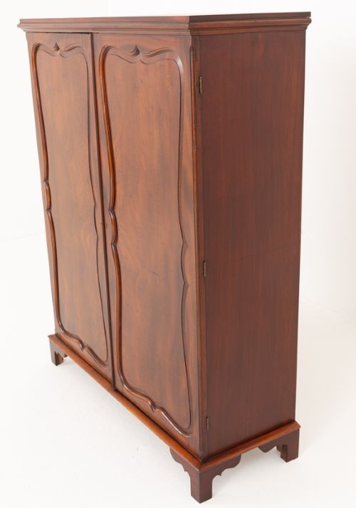 A Georgian mahogany side cabinet featuring two cupboard doors with shaped panel mouldings, brass escutcheons, and bracket feet. View VIII