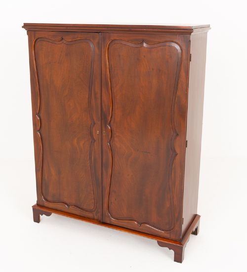 A Georgian mahogany side cabinet featuring two cupboard doors with shaped panel mouldings, brass escutcheons, and bracket feet. View IX