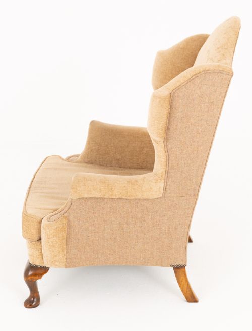 A pair of Georgian style wingback armchairs with tan textile upholstery, hump backs, shaped side wings, and walnut cabriole front legs. View III