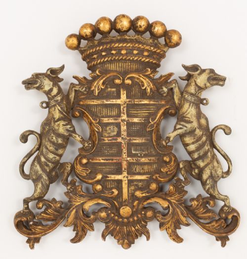 A gilded hardwood armorial shield featuring central cross quarterings flanked by two hound supporters and crowned with a ball-adorned coronet. View II