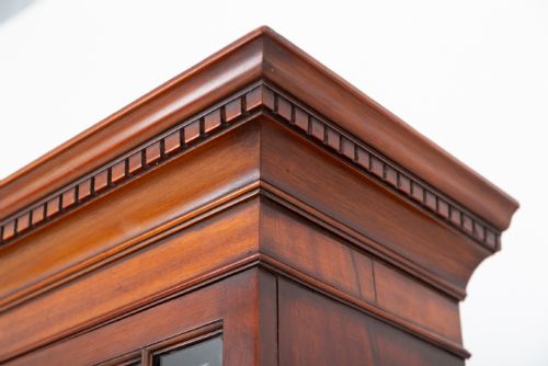 fig 1. A Georgian mahogany bureau bookcase featuring an upper cabinet with astragal glazed doors, a slant-front writing slope, four graduated drawers, and bracket feet.