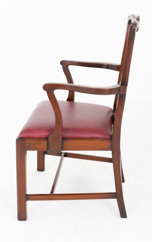 A set of ten mahogany Chippendale style dining chairs with carved pierced back splats and red upholstered seats. View V