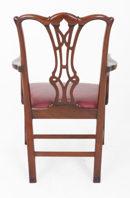 A set of ten mahogany Chippendale style dining chairs with carved pierced back splats and red upholstered seats. View VI