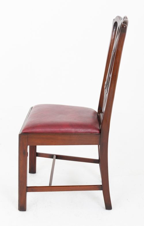 A set of ten mahogany Chippendale style dining chairs with carved pierced back splats and red upholstered seats. View VIII