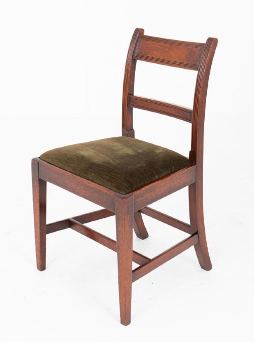 A set of six Georgian mahogany dining chairs with reeded frames and dark green velvet upholstered seats. View V