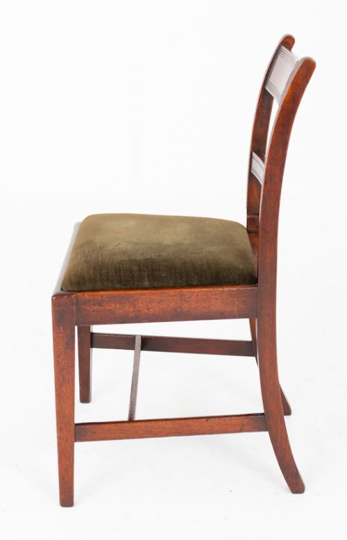 A set of six Georgian mahogany dining chairs with reeded frames and dark green velvet upholstered seats. View VI