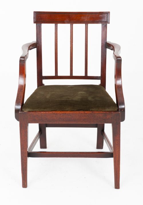 fig 1. A Georgian mahogany armchair with a vertical slatted backrest, curved arms, and an olive green velvet upholstered seat.