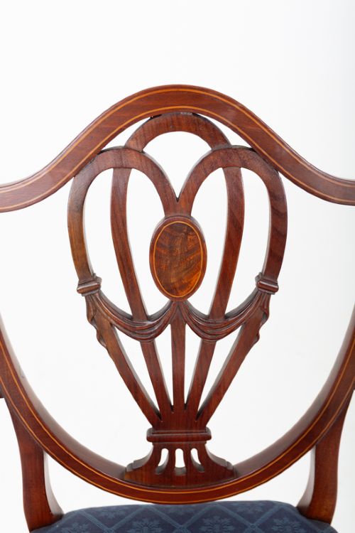 fig 3. A set of twelve mahogany Hepplewhite style dining chairs with shield backs, carved urn splats, and blue patterned upholstered seats.