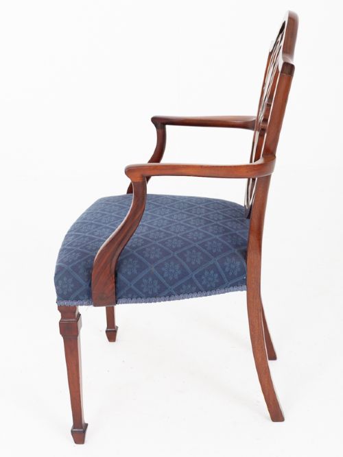 A set of twelve mahogany Hepplewhite style dining chairs with shield backs, carved urn splats, and blue patterned upholstered seats. View VII