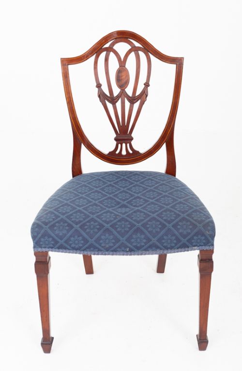 A set of twelve mahogany Hepplewhite style dining chairs with shield backs, carved urn splats, and blue patterned upholstered seats. View VIII