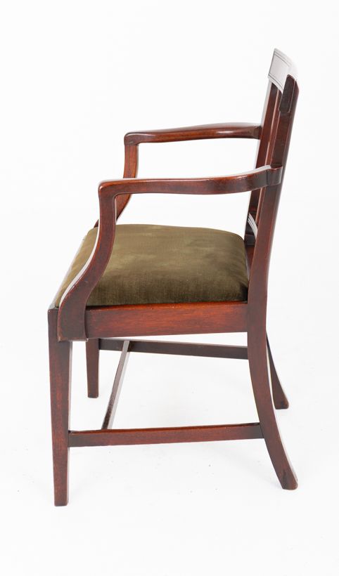 fig 2. A Georgian mahogany armchair with a vertical slatted backrest, curved arms, and an olive green velvet upholstered seat.