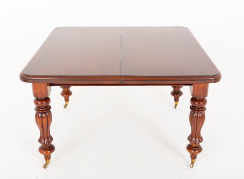 fig 1. A Victorian mahogany extending dining table with two insertable leaves, fluted turned legs, and brass castors.