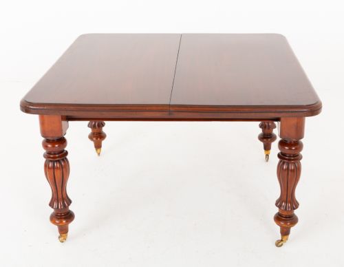 fig 2. A Victorian mahogany extending dining table with two insertable leaves, fluted turned legs, and brass castors.