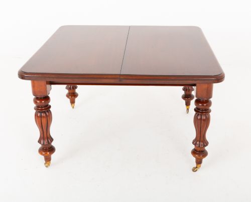 fig 3. A Victorian mahogany extending dining table with two insertable leaves, fluted turned legs, and brass castors.
