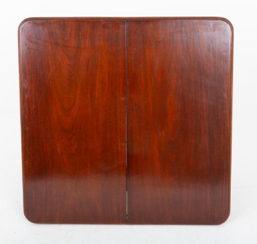 A Victorian mahogany extending dining table with two insertable leaves, fluted turned legs, and brass castors. View XII