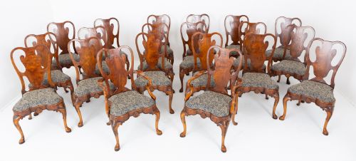 fig 1. A large set of twenty Queen Anne style elm dining chairs featuring shaped vasiform back splats, upholstered patterned seats, and cabriole legs with carved shell details.