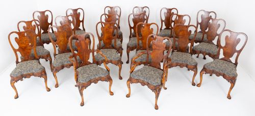fig 2. A large set of twenty Queen Anne style elm dining chairs featuring shaped vasiform back splats, upholstered patterned seats, and cabriole legs with carved shell details.