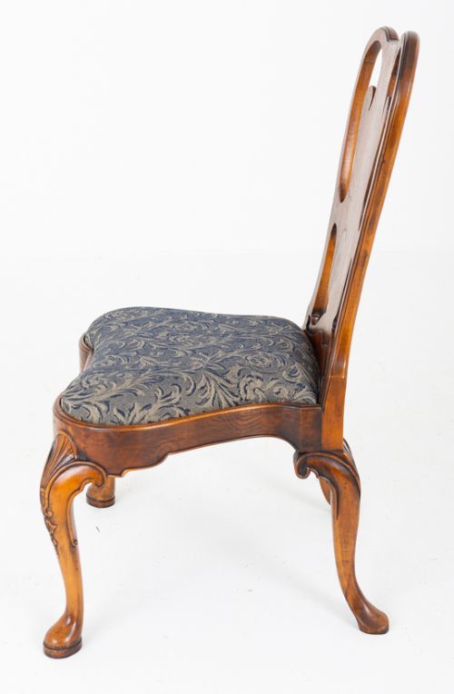 A large set of twenty Queen Anne style elm dining chairs featuring shaped vasiform back splats, upholstered patterned seats, and cabriole legs with carved shell details. View IX