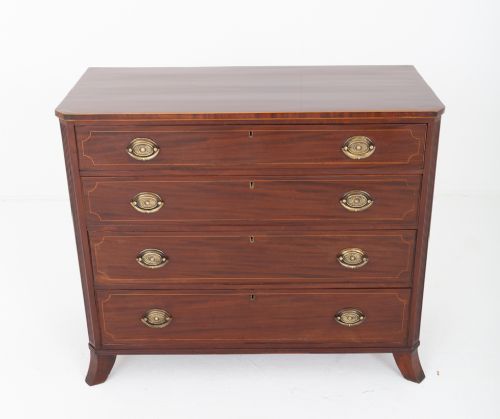 fig 1. A Regency mahogany chest of four graduated drawers featuring brass oval backplate handles, reeded side pilasters, and splayed bracket feet.