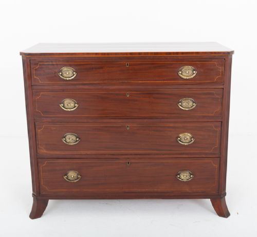 A Regency mahogany chest of four graduated drawers featuring brass oval backplate handles, reeded side pilasters, and splayed bracket feet. View IV