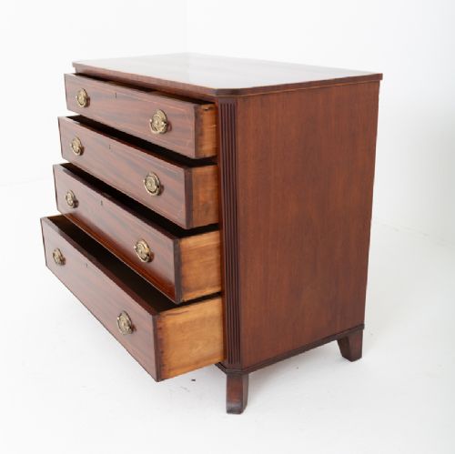 A Regency mahogany chest of four graduated drawers featuring brass oval backplate handles, reeded side pilasters, and splayed bracket feet. View VIII