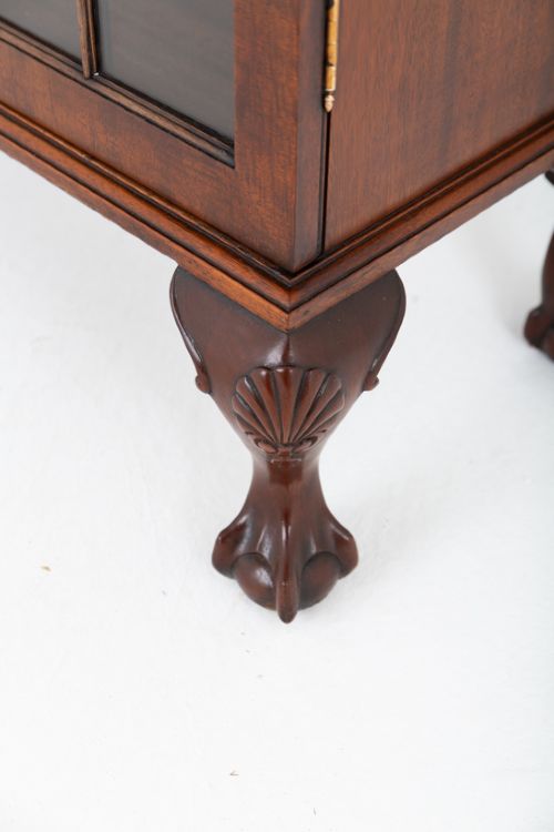 A low mahogany four-door side cabinet featuring geometric astragal glazed glass panels and carved claw and ball feet. View VI