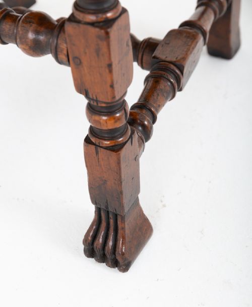 A set of ten brown leather upholstered oak dining chairs with brass studding and turned stretchers, including two carvers and eight side chairs. View VI