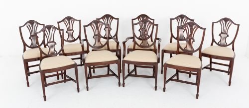 fig 1. A set of ten mahogany Hepplewhite style dining chairs with shield backs and cream patterned upholstered seats.