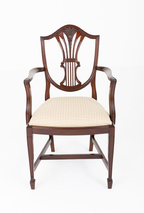 fig 2. A set of ten mahogany Hepplewhite style dining chairs with shield backs and cream patterned upholstered seats.