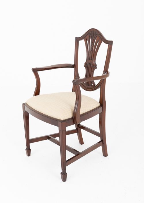 A set of ten mahogany Hepplewhite style dining chairs with shield backs and cream patterned upholstered seats. View IV
